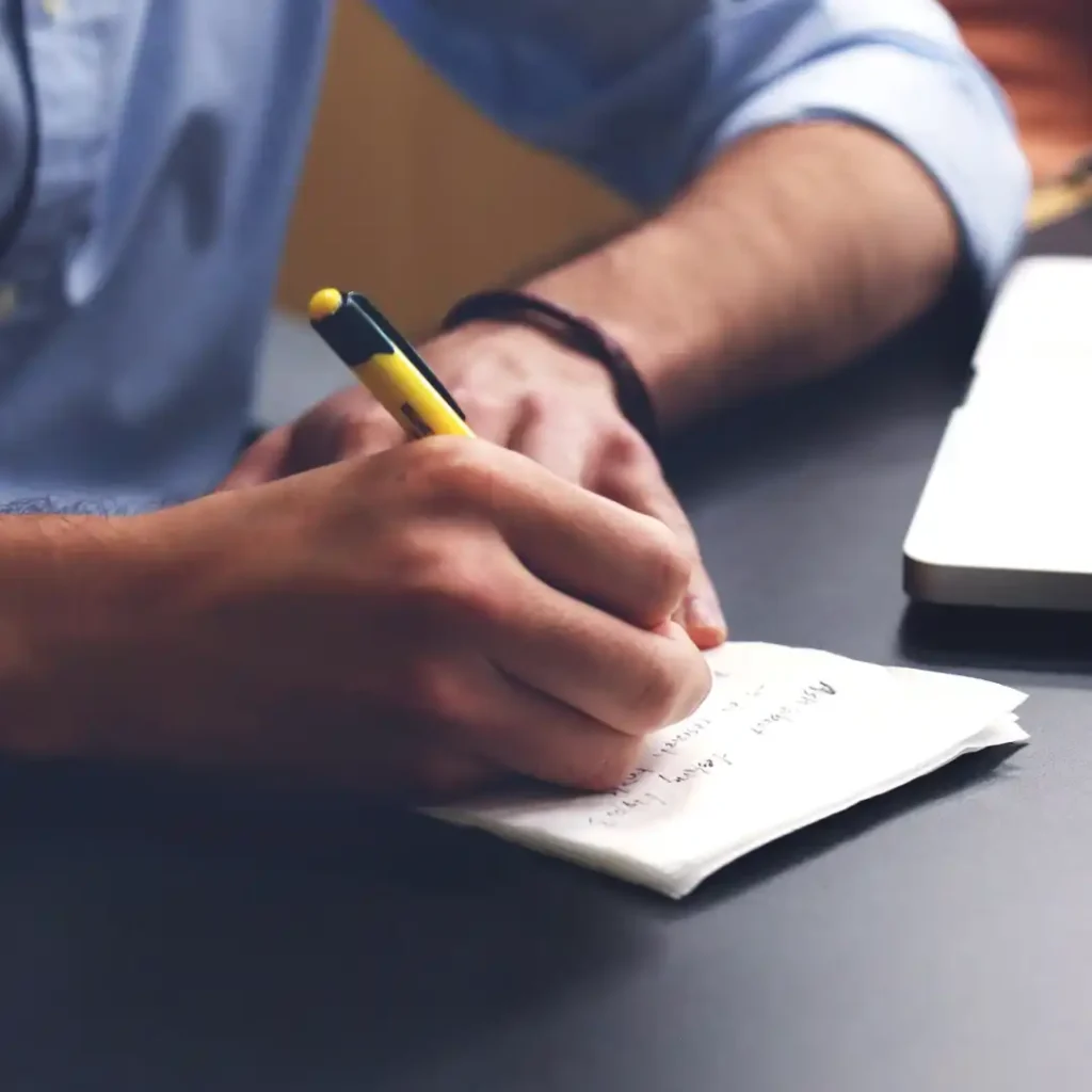 Person writing a 90-day career reinvention plan at a desk