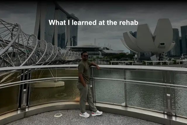 A man standing alone at a modern urban bridge with Marina Bay Sands in the background — a reflective moment symbolizing personal growth, healing, and lessons learned from rehab. The title of this blog post is: What no one tells you about addiction. In this blog post I talk about my time at the rehab.